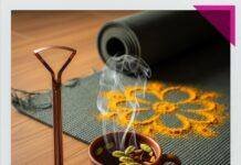 Ayurvedic Detoxification Methods for Holistic Cleansing A coppery tongue scraper, a steaming tea cup, and a yoga mat.