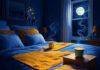 Enhancing Sleep Quality with Ayurvedic and Yogic Practices Cozy bedroom with indigo bed, saffron blanket, steaming turmeric milk, glowing dreamcatcher under moonlight.